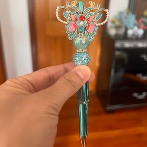 Butterfly Adorned Pen with Teal and Pink Details
